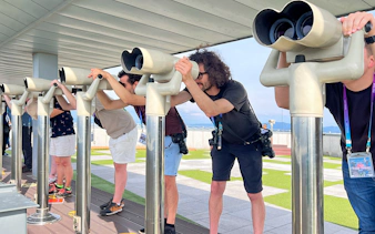 Visitors using binoculars at the DMZ observatory in Korea.