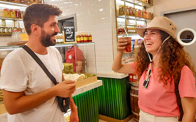 Tourists enjoying a local drink at a shop on Istanbul's Asian side during a walking tour.