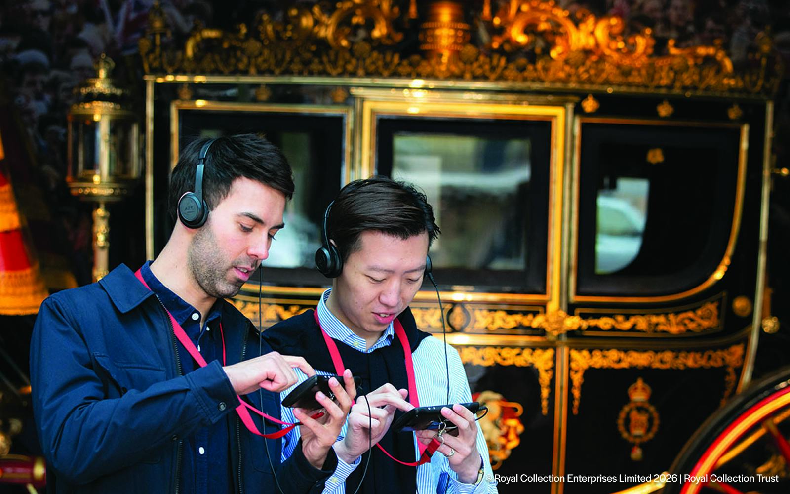 Visitors using audio guides at the Royal Mews, London.