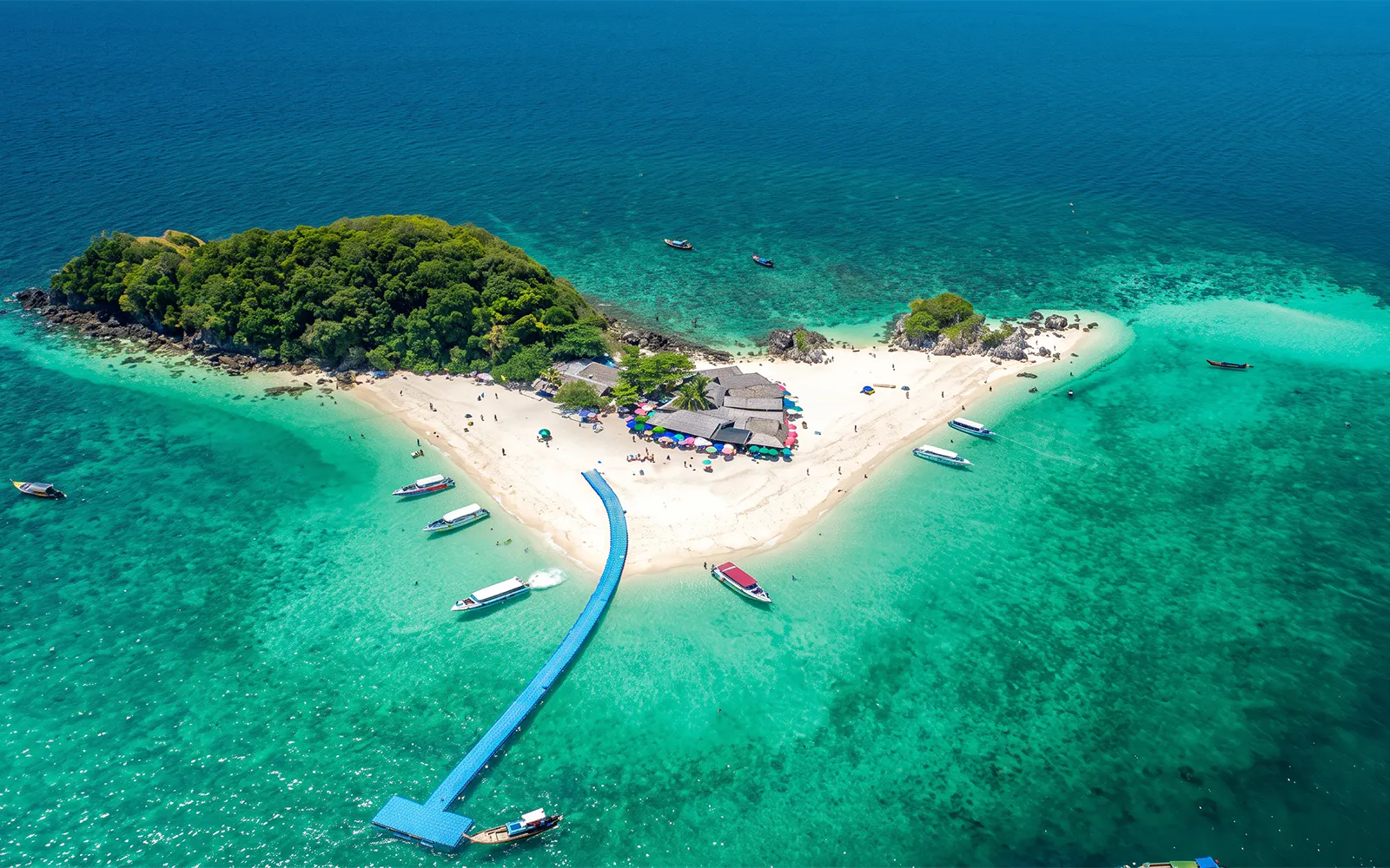 Aerial view of Khai Island with speedboats and turquoise waters near Phuket.