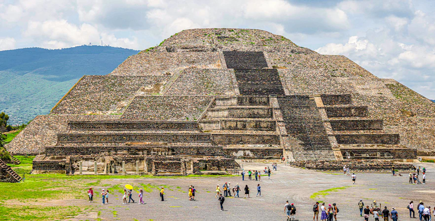 Pyramid of the Moon in Teotihuacan, Mexico, with visitors exploring the site.