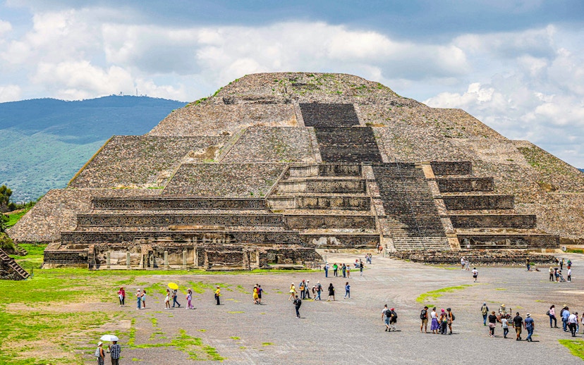Pyramid of the Moon in Teotihuacan, Mexico, with visitors exploring the site.