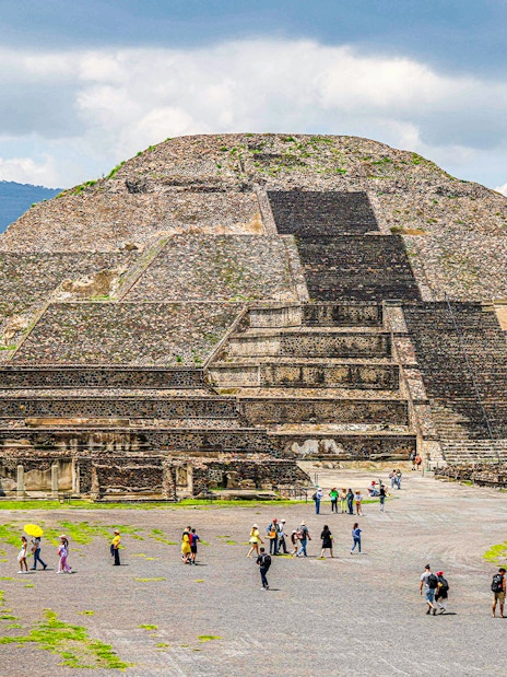Pyramid of the Moon in Teotihuacan, Mexico, with visitors exploring the site.