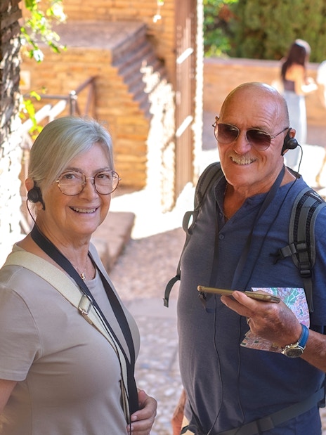 Visitors using audio guides at Montserrat Monastery entrance.