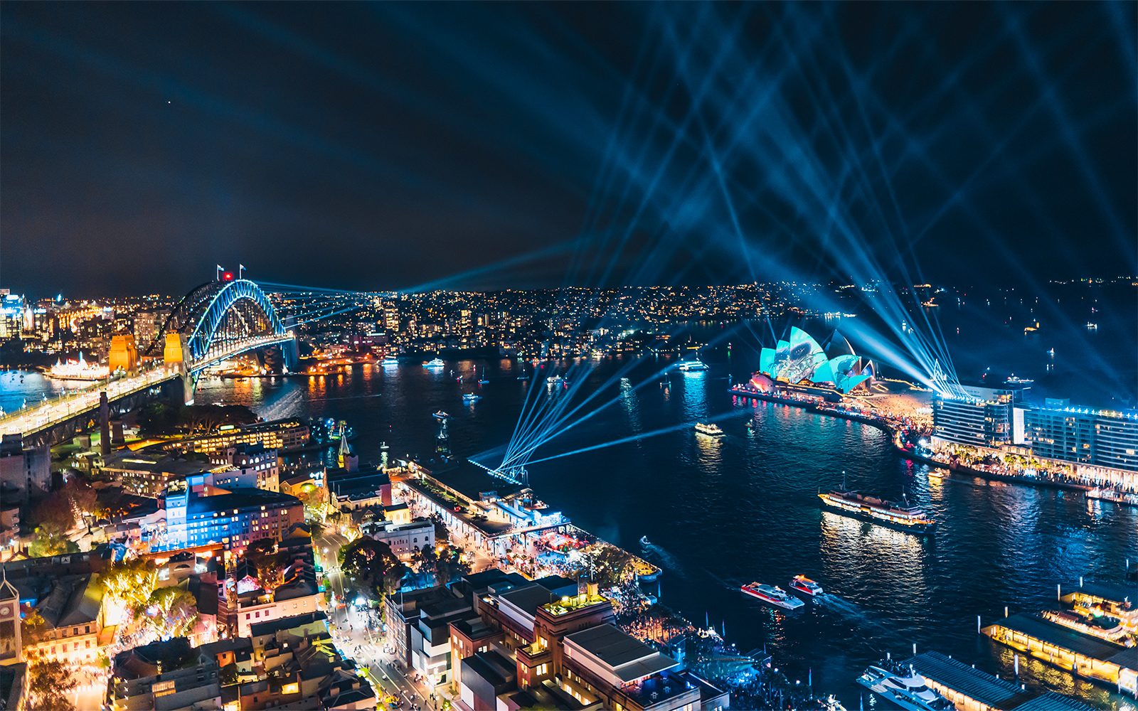Sydney Harbour Bridge and Opera House illuminated during Vivid Sydney event.