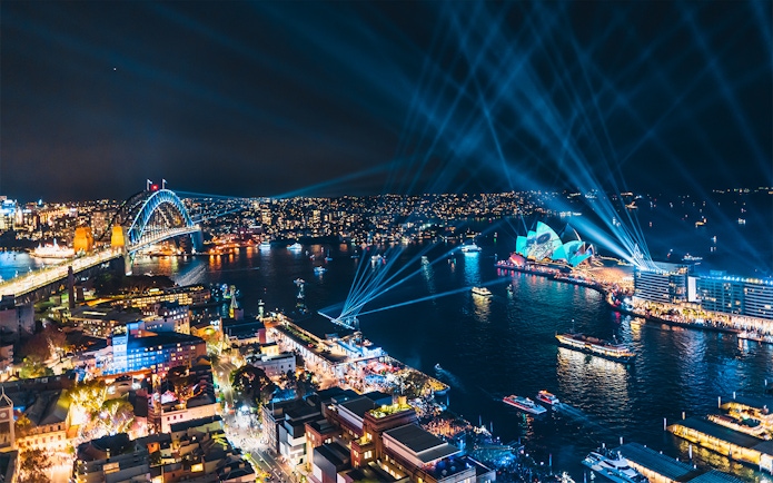 Sydney Harbour Bridge and Opera House illuminated during Vivid Sydney event.