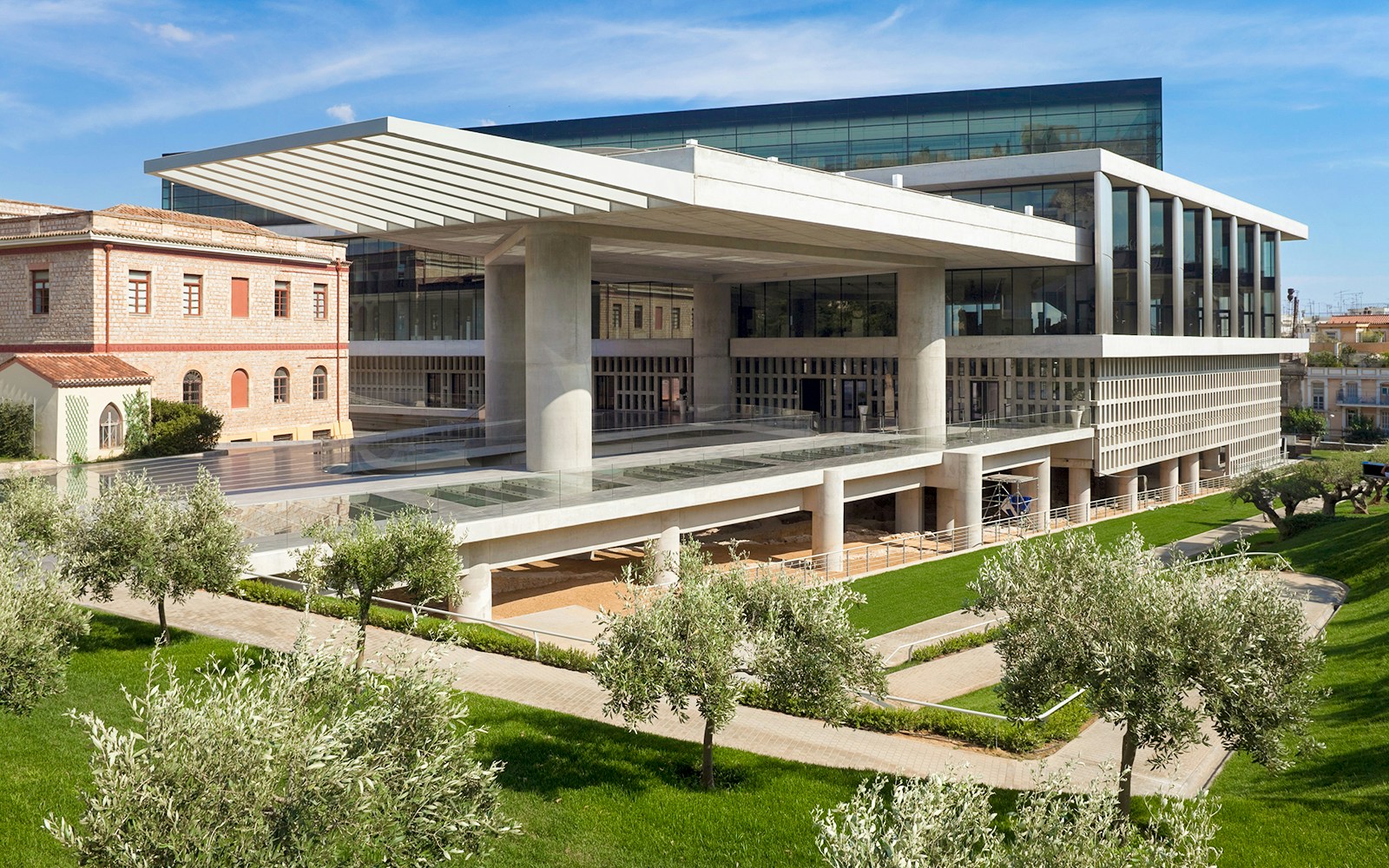 Acropolis Museum exterior with modern architecture and surrounding greenery in Athens, Greece.