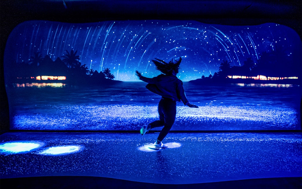 Customer enjoying bioluminescence exhibit at SEA LIFE Sydney Aquarium.