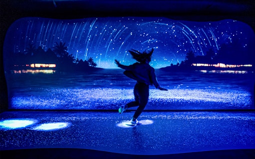 Customer enjoying bioluminescence exhibit at SEA LIFE Sydney Aquarium.