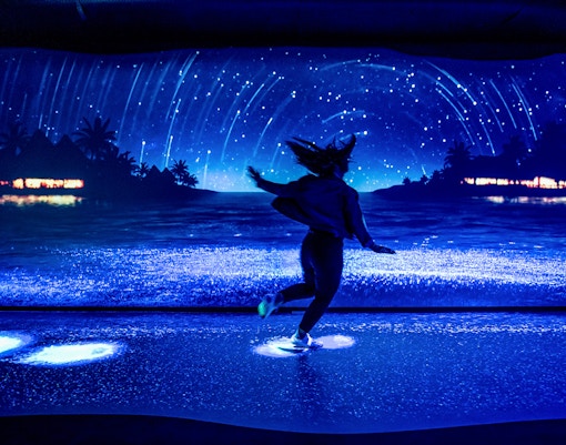 Customer observing bioluminescence exhibit at SEA LIFE Sydney Aquarium, Australia.