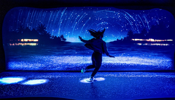 Customer observing bioluminescence exhibit at SEA LIFE Sydney Aquarium, Australia.