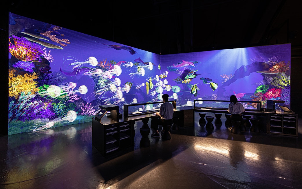 Live sketch exhibit at ARTE Museum Dubai featuring vibrant underwater scene.
