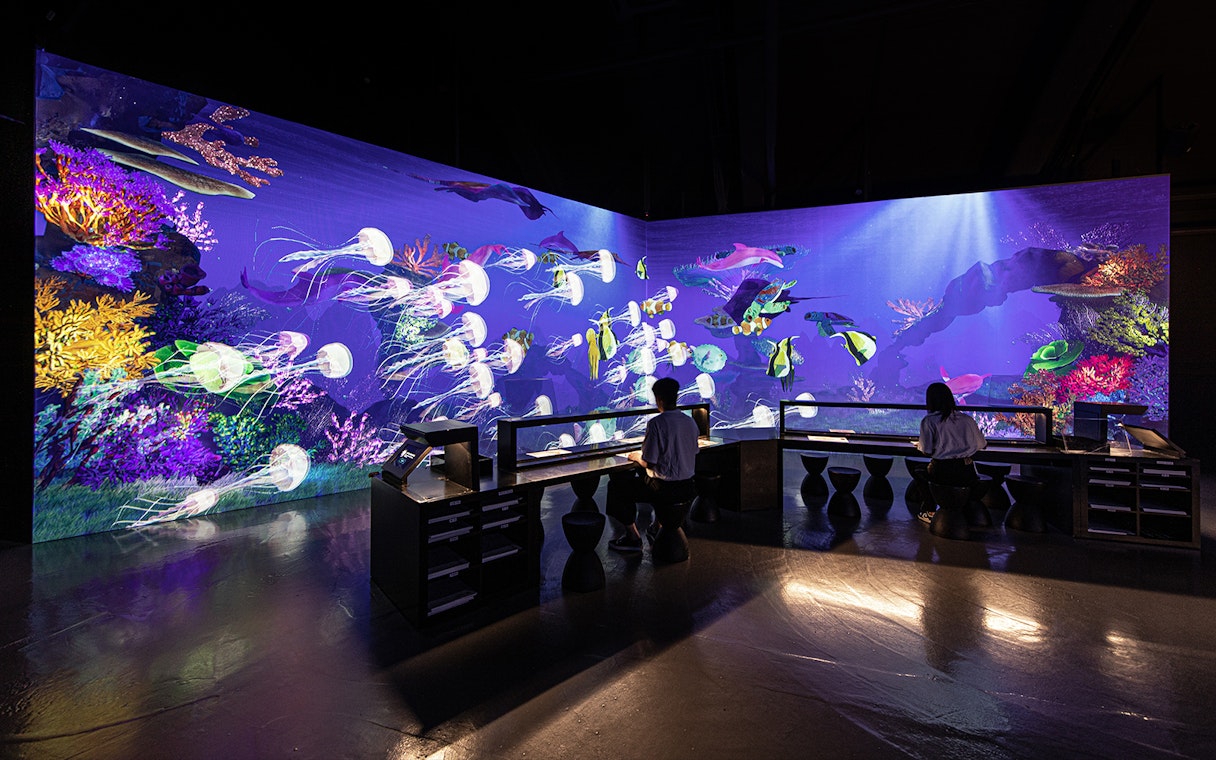 Live sketch exhibit at ARTE Museum Dubai featuring vibrant underwater scene.