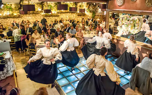 Folklore dancers performing at a traditional Maltese restaurant dinner show.
