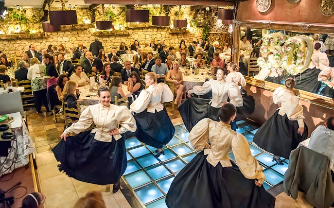 Folklore dancers performing at a traditional Maltese restaurant dinner show.