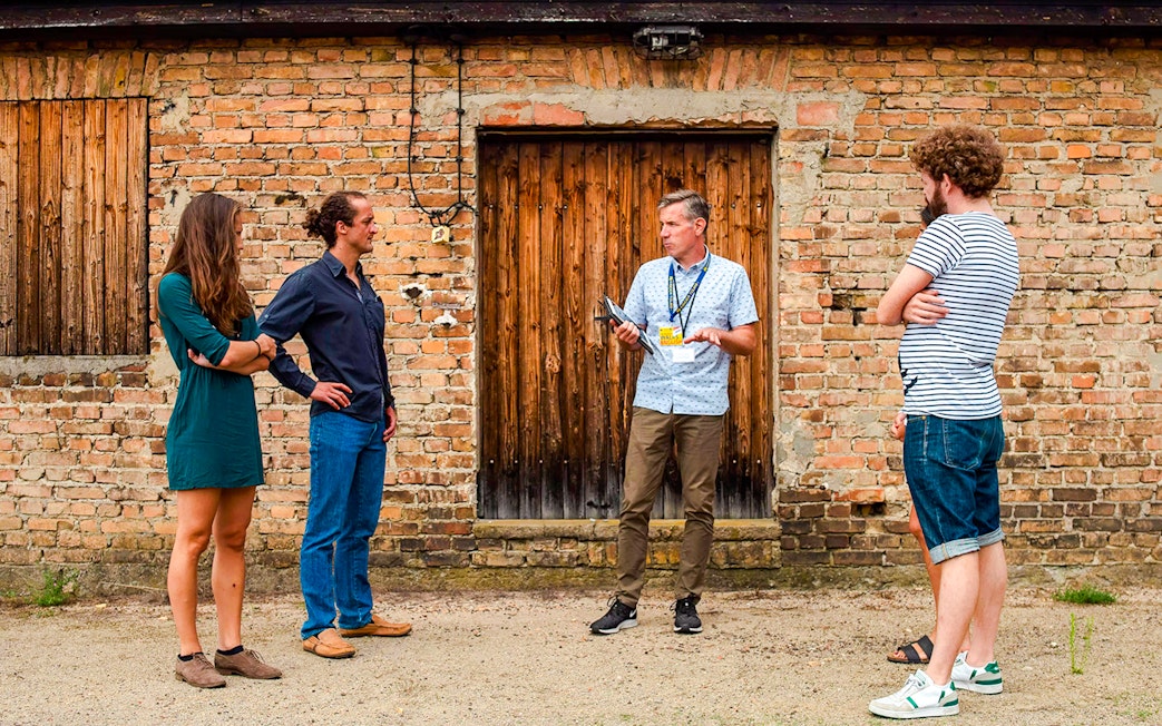 Guests with a tour guide at Sachsenhausen Concentration Camp Memorial, Germany.