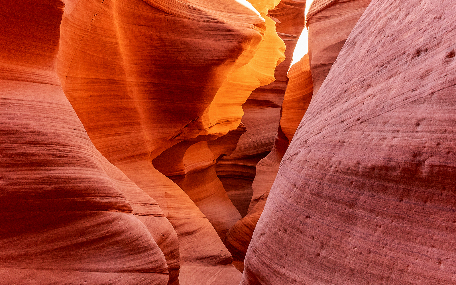 Antelope Canyon X sandstone formations illuminated by sunlight.
