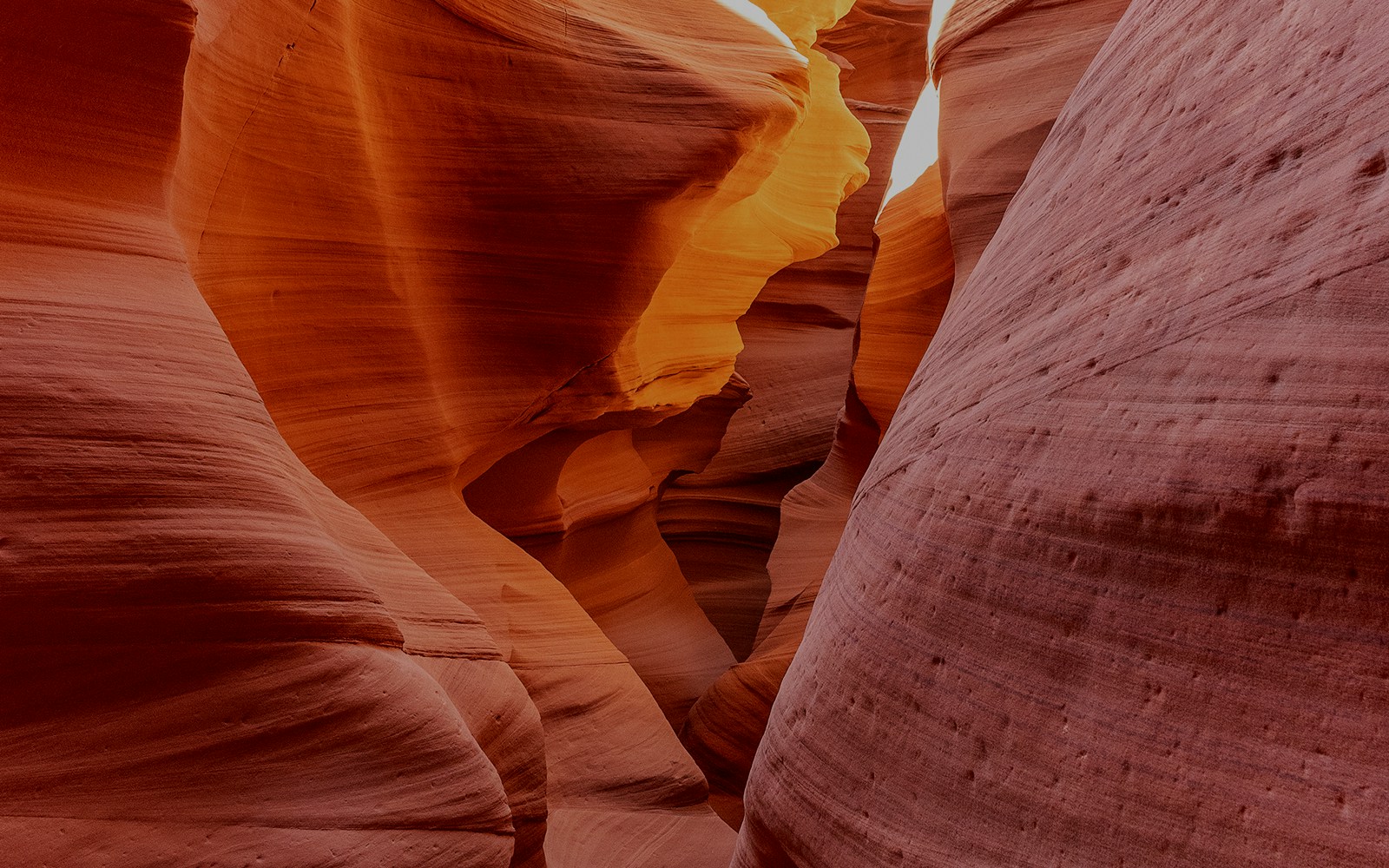 Antelope Canyon X sandstone formations illuminated by sunlight.