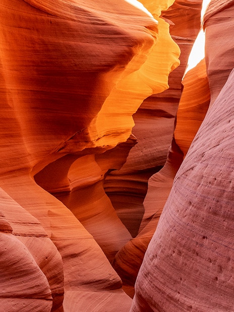 Antelope Canyon X sandstone formations illuminated by sunlight.