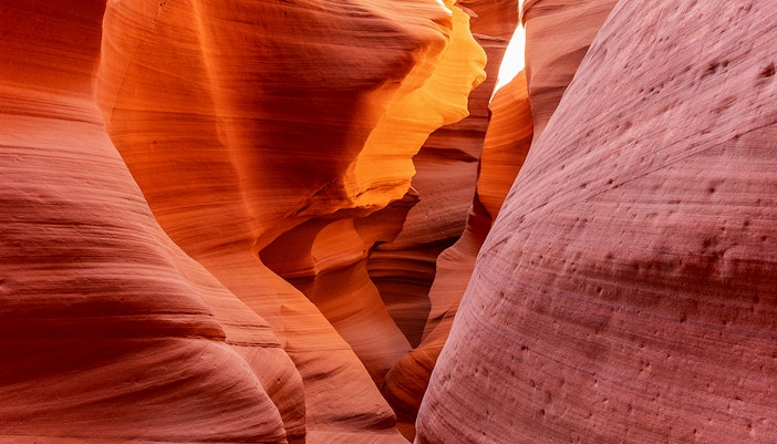 Antelope Canyon X sandstone formations illuminated by sunlight.