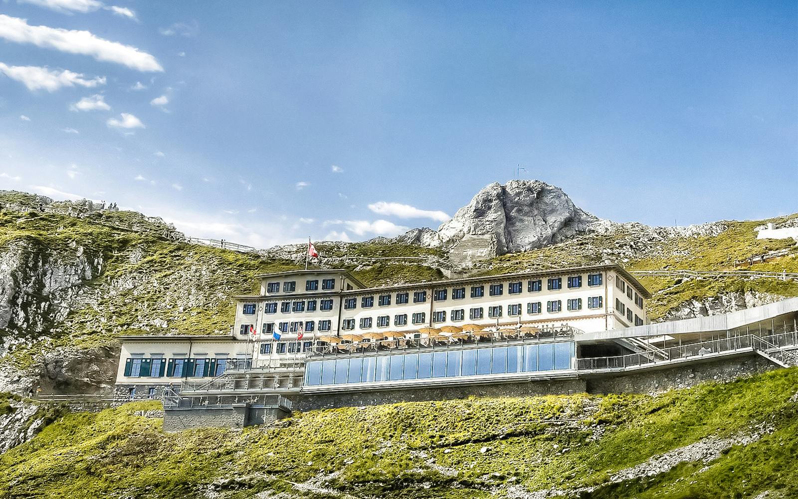Mount Pilatus summit building with Swiss flag, part of Golden Round Trip from Lucerne.