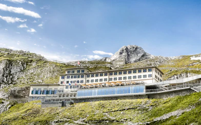 Mount Pilatus summit building with Swiss flag, part of Golden Round Trip from Lucerne.