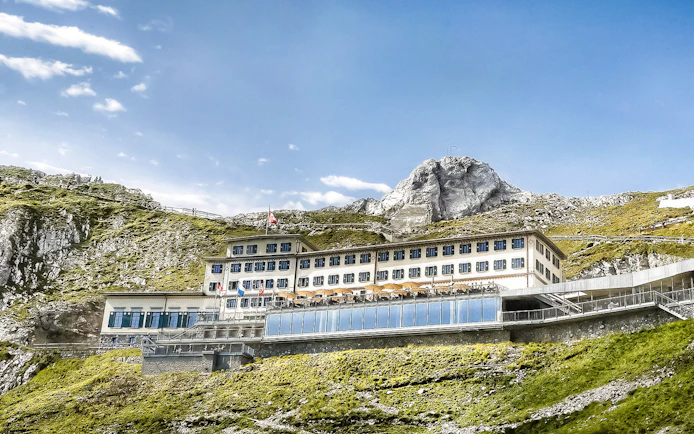 Mount Pilatus summit building with Swiss flag, part of Golden Round Trip from Lucerne.