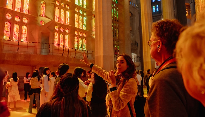 Sagrada Familia interior with vibrant stained glass windows during a guided tour in Barcelona.
