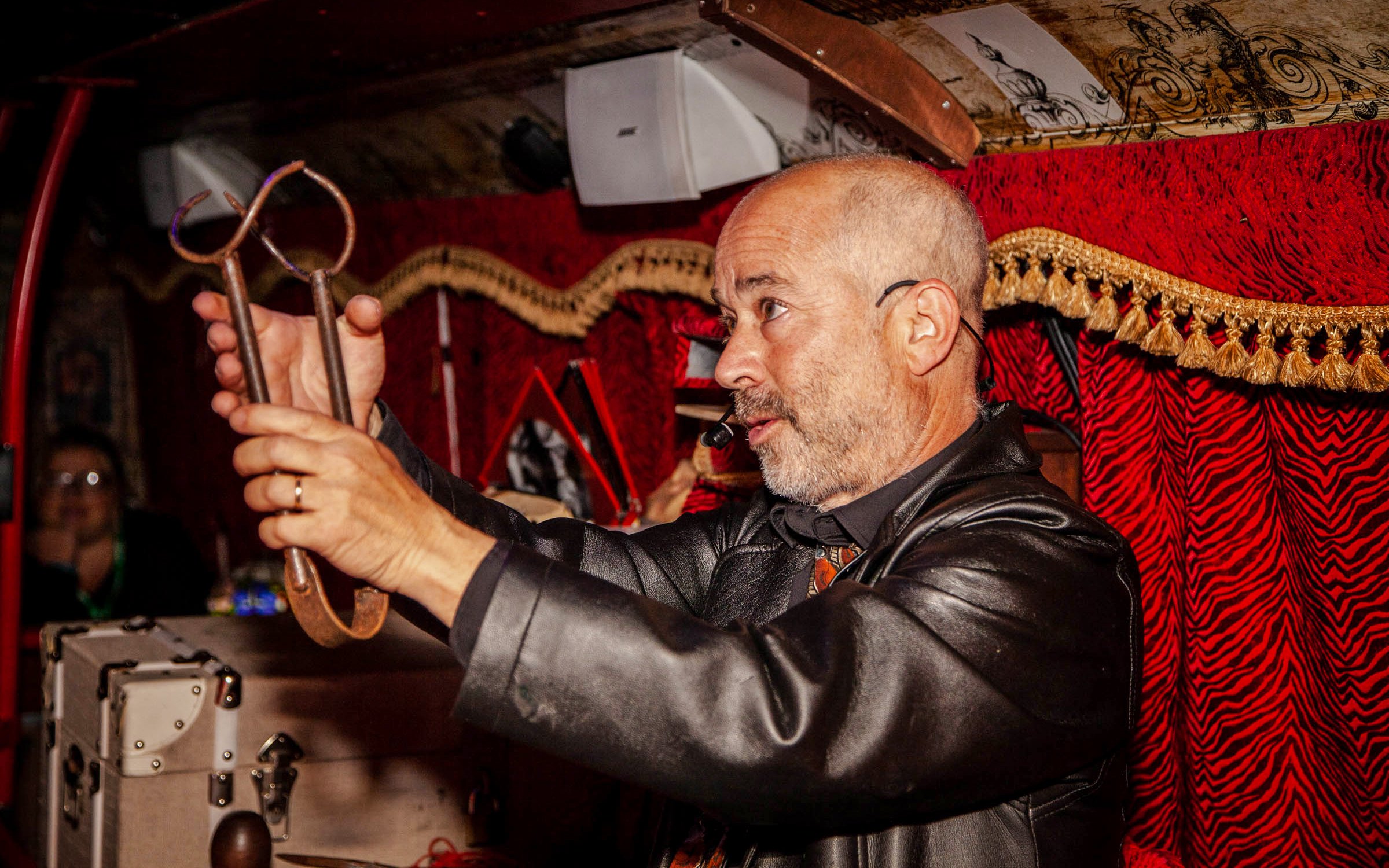 Tour guide demonstrating ghost hunting tools on Dublin Ghostbus Tour.