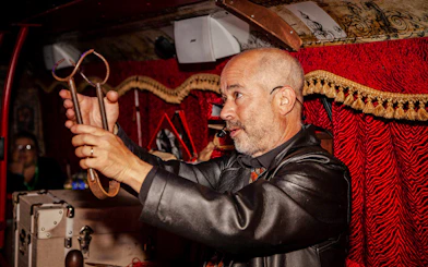 Tour guide demonstrating ghost hunting tools on Dublin Ghostbus Tour.