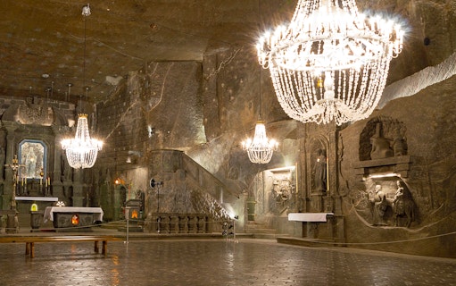 Wieliczka Salt Mine chapel with chandeliers and carved salt sculptures, Poland.