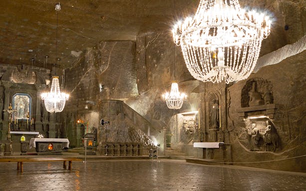 Wieliczka Salt Mine chapel with chandeliers and carved salt sculptures, Poland.