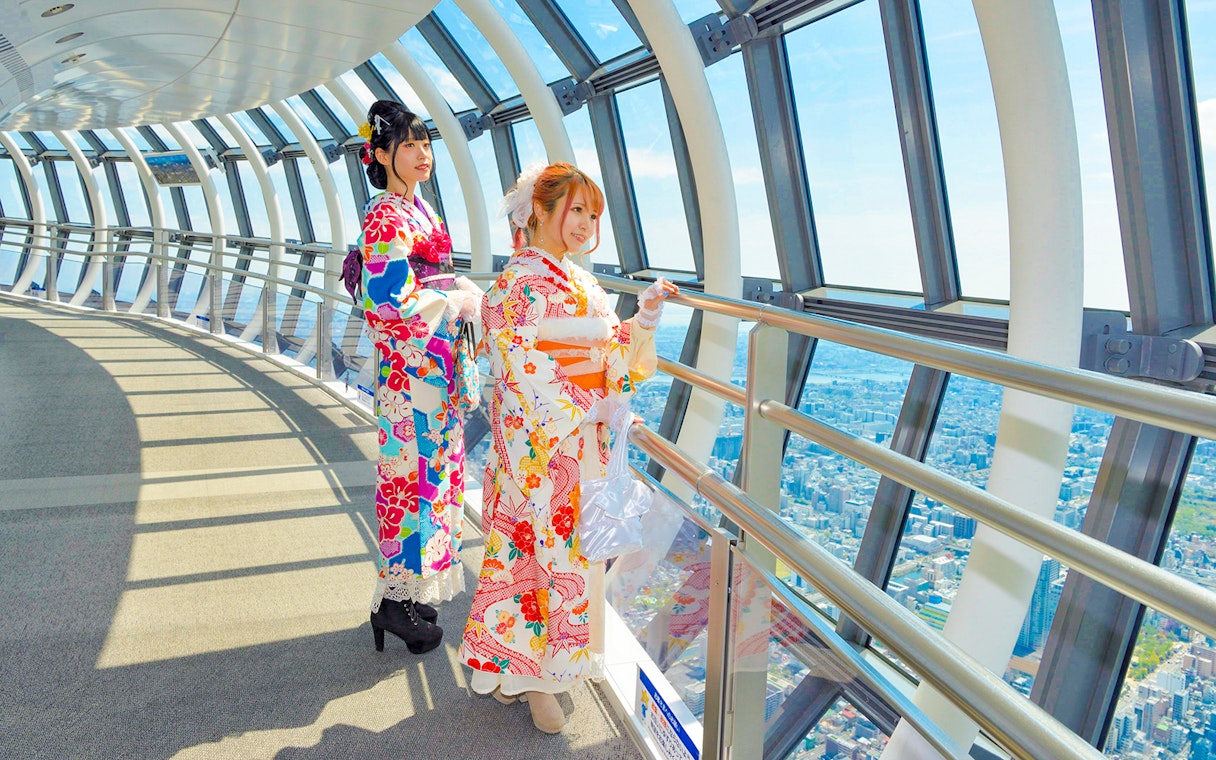 Visitors in kimonos enjoying the view from Tokyo Skytree observation deck.