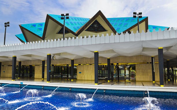 National Mosque of Malaysia with blue roof and fountains, Kuala Lumpur Half Day City Tour.