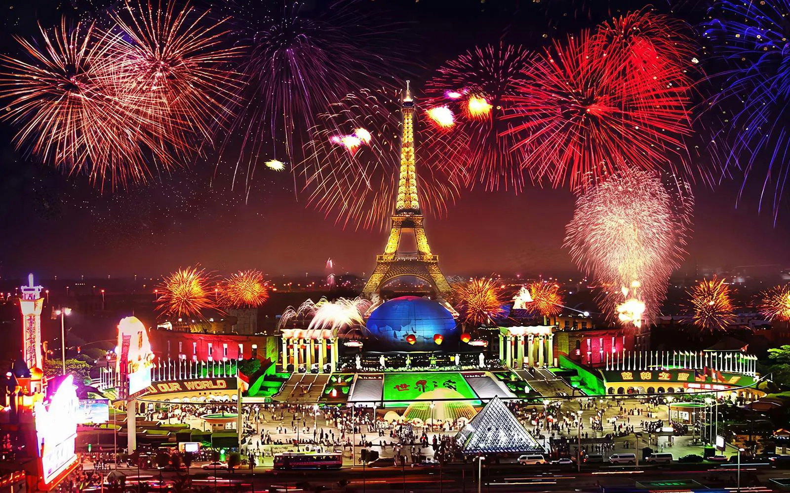 Nighttime fireworks over Eiffel Tower replica at Window of the World, Shenzhen, China.