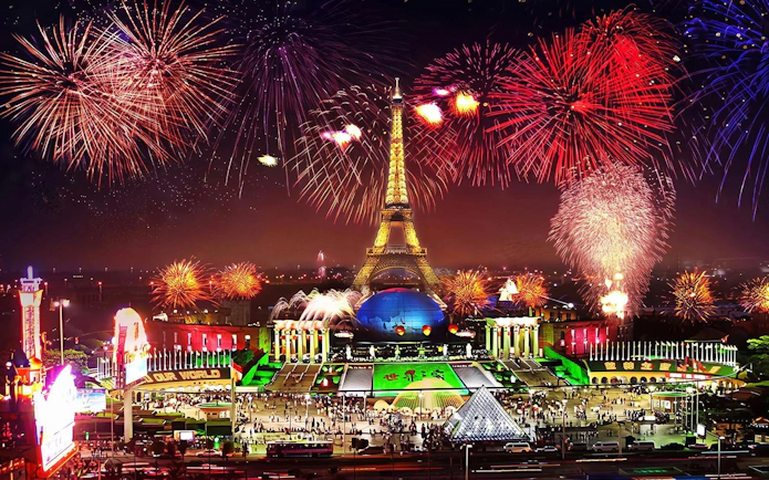 Nighttime fireworks over Eiffel Tower replica at Window of the World, Shenzhen, China.