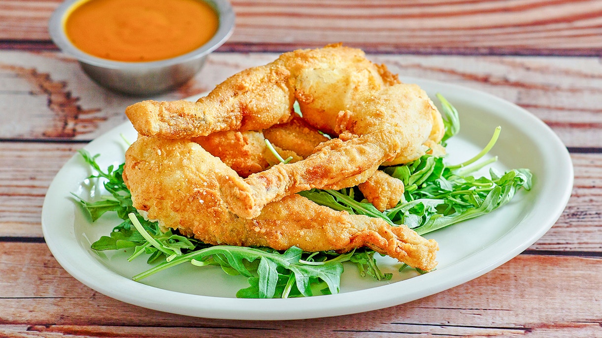 Fried frog legs on arugula with dipping sauce at Everglades National Park.