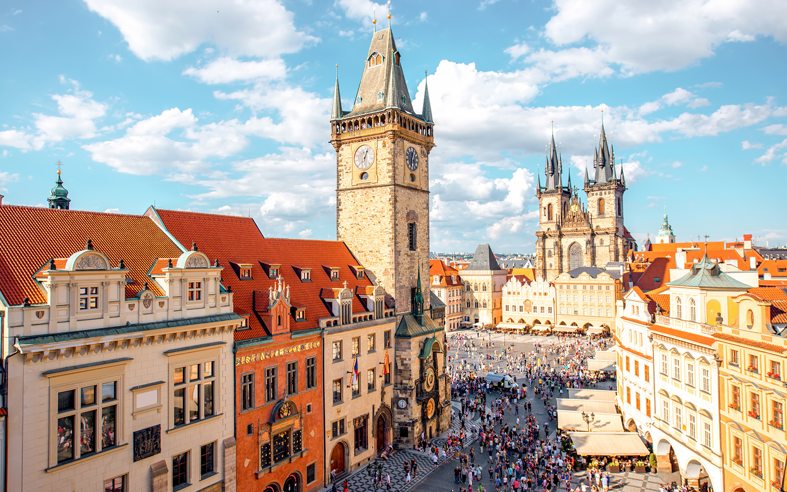 Cityscape view on the clock tower and Tyn cathedral on the old square in Prague.