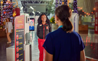 FacePass entry system at Ferrari World Abu Dhabi with staff assisting visitors.