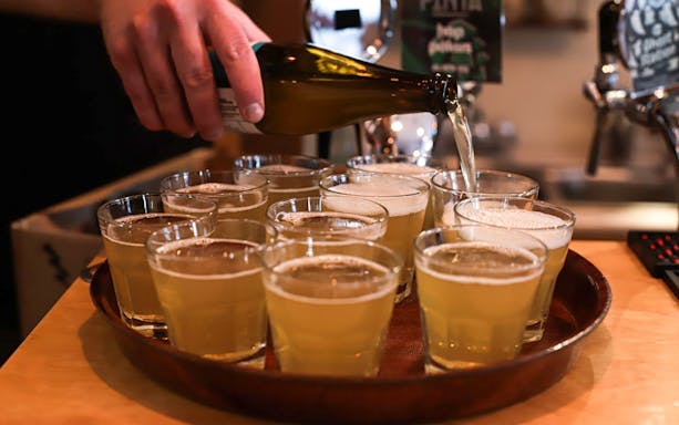 Pouring craft beer into glasses on Kraków Walking Craft Beer Tour.