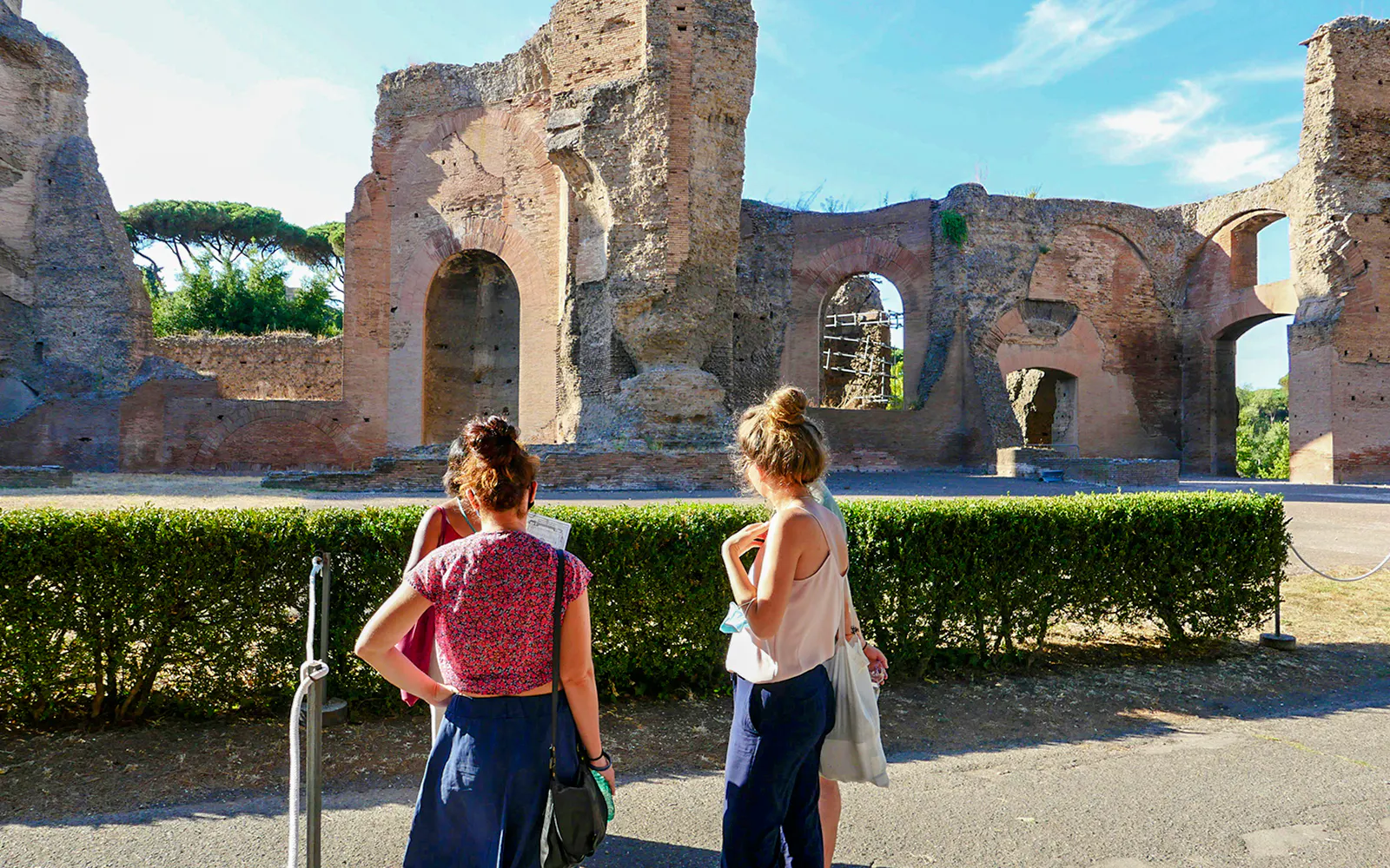 Visitors exploring the ancient Baths of Caracalla ruins in Rome, Italy.
