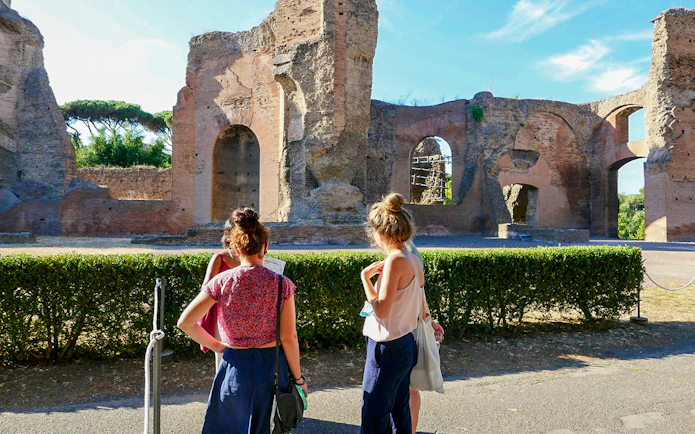 Visitors exploring the ancient Baths of Caracalla ruins in Rome, Italy.