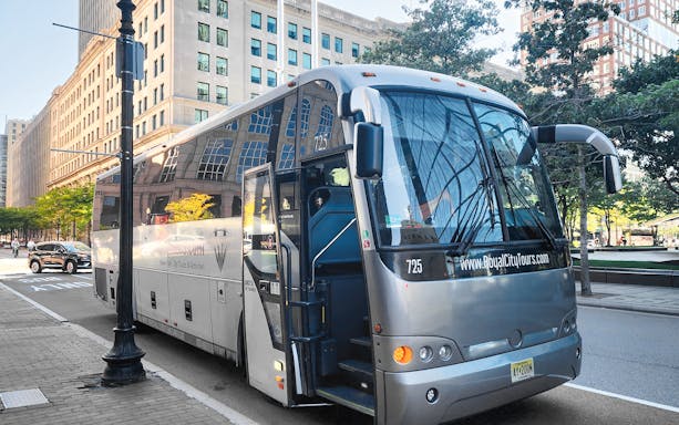Roundtrip bus transfer to Niagara Falls parked on city street.