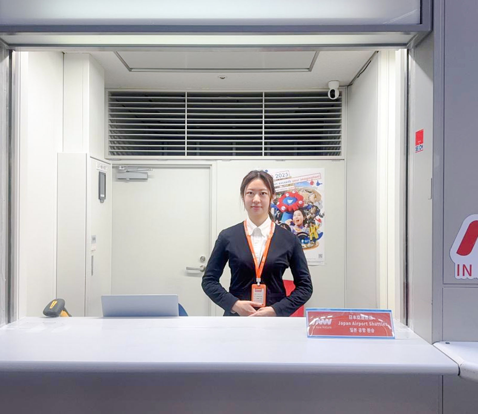 Kansai Airport shuttle reception desk with staff ready for hotel drop-off service.