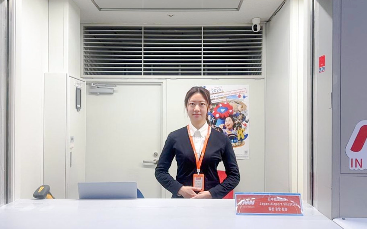 Kansai Airport shuttle reception desk with staff ready for hotel drop-off service.
