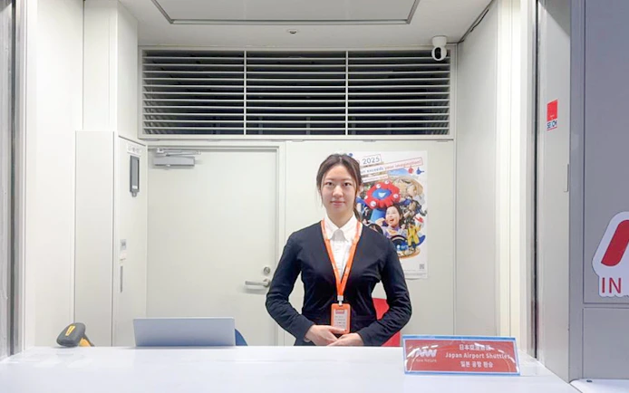 Kansai Airport shuttle reception desk with staff ready for hotel drop-off service.