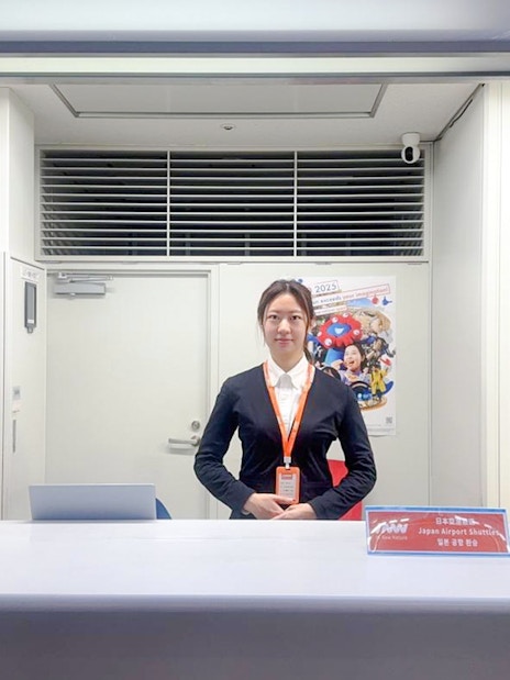 Kansai Airport shuttle reception desk with staff ready for hotel drop-off service.