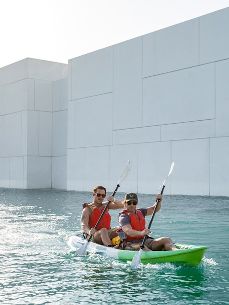 Kayakers paddling near Louvre Abu Dhabi on a guided tour.