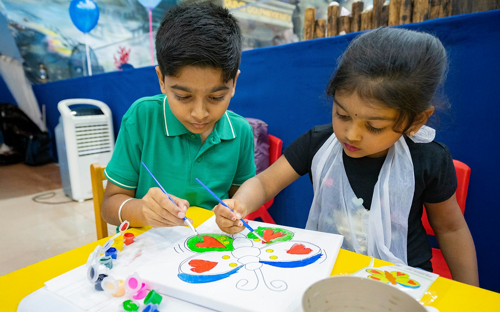 Kids indulged in colouring a butterfly at Dubai Dolphinarium Art Factory
