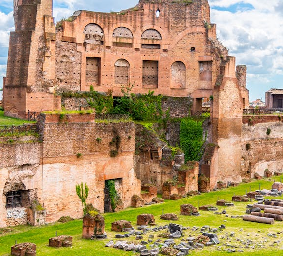 Ancient ruins of the Stadium of Domitian in Rome, showcasing brick arches and stone remnants.